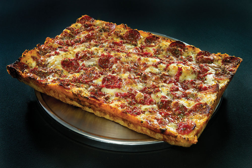 Pizza Marketing Quarterly: Highlighting the distinctive square shape and layered flavors of Detroit-style pizza.