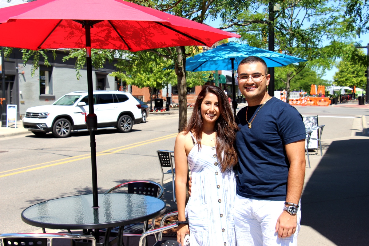 A young couple enjoys the lively atmosphere in Historic Downtown Northville.